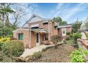 Side angle view of a brick home with mature landscaping and an entrance porch at 105 Deaver St, Chester, SC 29706