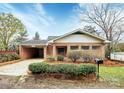 Charming brick home with a well-manicured front yard and an attached carport at 105 Deaver St, Chester, SC 29706