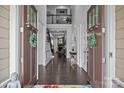 Inviting foyer with hardwood floors, high ceilings, and a view into the living room and staircase at 10904 Kilkenny Dr, Matthews, NC 28105