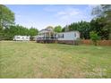 Spacious backyard offers ample space for outdoor activities and features mature trees and grass at 115 Oak Creek Rd, Statesville, NC 28625