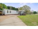 Charming single-story home with a welcoming front porch, driveway, and spacious yard at 115 Oak Creek Rd, Statesville, NC 28625