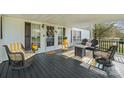 Inviting front porch features comfortable seating and charming decor, perfect for relaxing outdoors at 115 Oak Creek Rd, Statesville, NC 28625