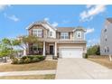 Beautiful two-story home with a manicured lawn, charming porch, and inviting curb appeal at 116 Rainbow Trout Trl, Fort Mill, SC 29715