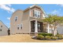 Inviting two-story home with charming front porch, beautiful landscaping, and a well-maintained yard at 116 Rainbow Trout Trl, Fort Mill, SC 29715
