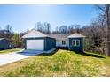 Charming single-story home with a two-car garage, surrounded by lush green lawn and trees at 1314 39Th Street Sw Cir, Hickory, NC 28602
