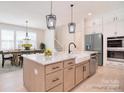 Open concept kitchen with large island, farmhouse sink, stainless appliances and adjacent dining area at 1378 Cedardale Ln, Denver, NC 28037