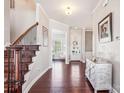 Welcoming foyer with hardwood floors, a staircase with iron spindles, and ample natural light at 15402 Country Lake Dr, Pineville, NC 28134