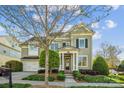 Charming two-story home with well-maintained landscaping, mature trees, and inviting entrance at 15402 Country Lake Dr, Pineville, NC 28134