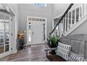Welcoming foyer with hardwood floors, staircase, and natural light at 1840 Sapona Ct, Denver, NC 28037