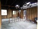 Stripped interior view of a room showcasing structural beams and window openings at 1842 Quail Run Dr, Kingstown, NC 28150