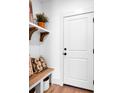 Functional mudroom includes a bench with storage and a door, perfect for organization at 221 Davidson Gateway Dr, Davidson, NC 28036