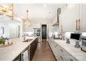 Bright kitchen featuring quartz countertops, stainless steel appliances and statement gold pendant lighting at 2332 Paddlers Cove Dr, Lake Wylie, SC 29710