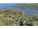 Beautiful Lake Norman waterfront property with a canopy of mature trees and private docks at 2792 Lakeshore Rd, Denver, NC 28037