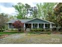 Charming single-story home featuring a welcoming front porch with stone accents and a well-maintained landscaped yard at 2792 Lakeshore Rd, Denver, NC 28037