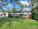A neatly landscaped yard in front of this brick home invites you in with classic charm at 3017 Lynwood Dr, Lancaster, SC 29720