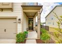 Inviting front entrance with a stylish wreath, decorative plants, and house number at 3021 Patchwork Ct, Fort Mill, SC 29708