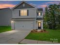 Charming two-story home with a two-car garage and well-maintained lawn, perfect for suburban living at 3034 Trailblazer St, Charlotte, NC 28215