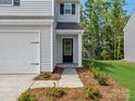 Close-up of the front entrance featuring a black door, manicured landscaping, and a welcoming porch at 3034 Trailblazer St, Charlotte, NC 28215