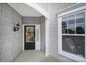 Inviting front entrance with a decorative wreath, sidelight, and gray shingle siding at 44455 Oriole Dr # 100, Indian Land, SC 29707