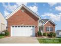 Attached two-car garage with brick facade and pristine driveway at 5172 Norway Rd, Rock Hill, SC 29732