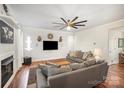 Bright living room with hardwood floors, modern ceiling fan, and comfortable gray couches at 5172 Norway Rd, Rock Hill, SC 29732