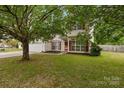 Charming two-story home featuring vinyl siding, red shutters, landscaped yard, and an attached two-car garage at 5519 Burning Ridge Dr, Monroe, NC 28110