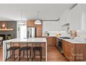 Modern kitchen with a large island, stainless steel appliances, wood cabinets, and hardwood floors at 6100 Rose Valley Dr, Charlotte, NC 28210