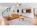 Open-concept living space with a brown sectional and bright natural light at 6312 Crosshall Pl, Waxhaw, NC 28173