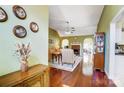 Open living room with hardwood floors, fireplace, and arched openings to adjoining spaces at 6420 Conifer Cir, Indian Trail, NC 28079