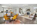 Open-concept living space featuring a fireplace, dining area, and modern kitchen at 68 Cabarrus W Ave, Concord, NC 28025