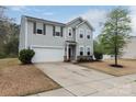 Charming two-story home with a well-manicured lawn and attached two-car garage at 7217 Cedarfield Rd, Charlotte, NC 28227