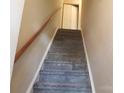 Carpeted staircase with wooden handrail leads to upper level at 9156 Black Heath Cir, Charlotte, NC 28214