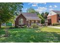 Charming brick home featuring a lush green lawn and well-maintained landscaping in a desirable neighborhood at 1008 Autumn Ln, Concord, NC 28025