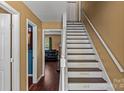 Unique staircase with custom painted lettering on each step leading to the upper level at 1008 Autumn Ln, Concord, NC 28025