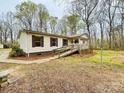 Cozy single-story home featuring a convenient ramp, set amidst a tranquil wooded backdrop at 1031 Lester Trl, Iron Station, NC 28080