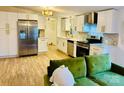 Well-lit kitchen featuring white cabinets, stainless steel appliances, and modern countertops at 1031 Lester Trl, Iron Station, NC 28080