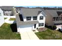 Well-maintained home featuring a two-car garage, and manicured lawn at 10848 Tailwater St, Davidson, NC 28036