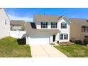 Attractive home featuring a two-car garage, neat lawn and classic suburban charm at 10848 Tailwater St, Davidson, NC 28036