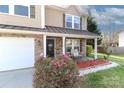 Inviting front porch with stone accents, seating, and beautiful landscaping details at 1135 Valley St, Statesville, NC 28677
