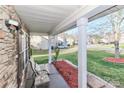 Covered front porch with stone accents, seating area and view of the street at 1135 Valley St, Statesville, NC 28677