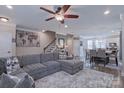 Spacious living area featuring a large sectional sofa, adjacent to a dining area and kitchen at 119 Capital Ave # E, Mooresville, NC 28117