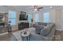 Cozy living room with a plush sectional sofa, large windows, and elegant decor at 119 Capital Ave # E, Mooresville, NC 28117