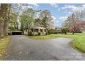 Well-maintained home with detached garage, circular driveway, and mature trees at 119 E End Ave, Statesville, NC 28677