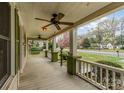 Relaxing covered front porch with ceiling fans and views of the neighborhood street at 119 E End Ave, Statesville, NC 28677