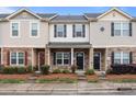 Charming townhome featuring stone accents, neutral siding, black shutters, and well-maintained landscaping at 12550 Mcgrath Dr, Charlotte, NC 28269