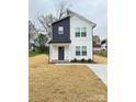 Front view of a charming two-story home with white siding, dark accents, and a welcoming front porch at 1406 Mason St, Kannapolis, NC 28081