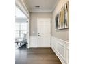 Welcoming foyer with dark wood floors, elegant wainscoting, and stylish decor at 1625 Carolina Orchards Blvd, Fort Mill, SC 29715