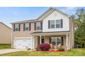 Charming two-story home with a well-manicured lawn and a spacious two-car garage at 200 Boysenberry Dr, China Grove, NC 28023