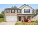 Charming two-story home with a well-manicured lawn and a spacious two-car garage at 200 Boysenberry Dr, China Grove, NC 28023