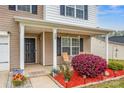 Inviting front porch with seating and landscaping, creating a cozy outdoor space at 200 Boysenberry Dr, China Grove, NC 28023